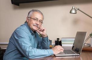 Senior businessman works at home photo