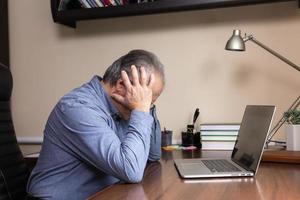 Senior man learns to use the computer photo