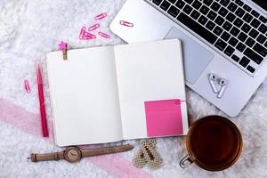 Home office desk workspace with laptop and tea cup on white background photo