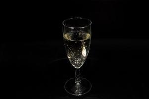 Champagne glass on black background photo
