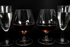 Glasses with different drinks brandy whiskey champagne or bourbon photo