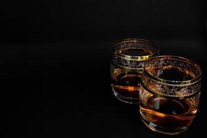 Glass of dark red whiskey brandy or bourbon photo