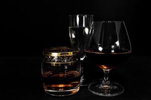 Glasses with different drinks brandy whiskey champagne or bourbon photo
