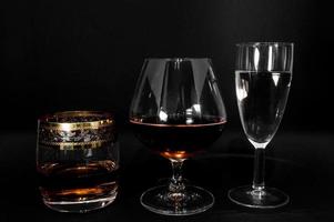 Glasses with different drinks brandy whiskey champagne or bourbon photo