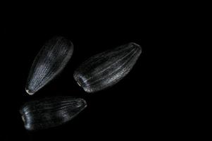 Sunflower seeds in  macro on black background photo