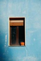 window on the blue facade of the house photo