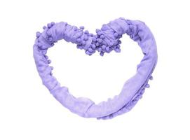 Frame in the shape of a heart of twisted purple fabric isolated on white background photo