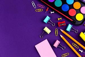School office supplies stationery on a purple background photo