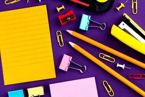 School office supplies on a purple background desk photo