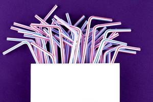 Plastic tubes on blue purple background photo