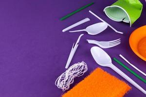 Orange, white and green packaging plastic products on purple background photo