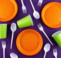 Plastic orange green waste collection on purple background