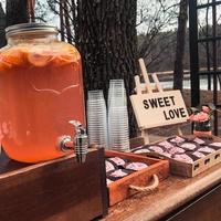 Location with summer drinks in glass jars or cupcake cans with a sign that says sweet love photo