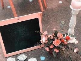 A bouquet in a rustic style with a frame and a black board for drawing a place for text photo