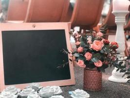 A bouquet in a rustic style with a frame and a black board for drawing a place for text photo