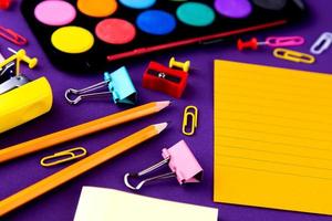 School office supplies stationery on a purple background photo