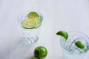 A glass of soda lemon and lime on the table photo