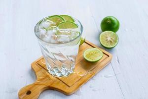 A glass of soda lemon and lime on the table photo