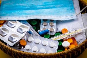 Wicker basket filled with medical supplies and medications photo