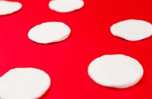 Pattern of cotton pads with hard shadows on a red background photo