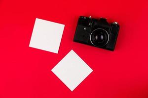 Flat lay film camera isolated on red background photo