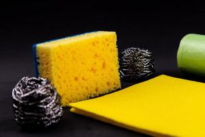 Different washcloths and scrubbers on a black background photo