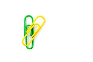 Green and yellow paper clips isolated on white background