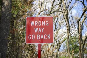 Red wrong way go back sign in the road photo