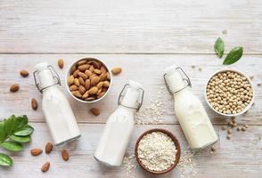 Bottles with different vegetable milk photo