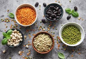 Bowls with different types of legumes photo