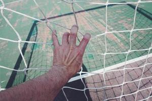 hand touching a rope net photo