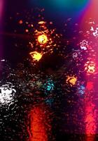 rain on the window at night on the street photo