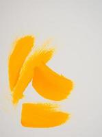 Handmade hand painted of yellow acrylic brush strokes on white photo