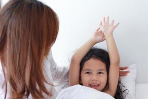 Asian mother and daughter wake up in the morning refreshed photo