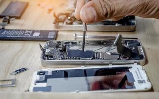 Phone motherboard repairs into the motherboard for smartphone By professional technician photo