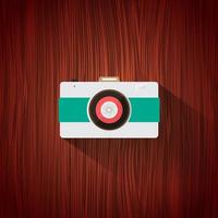 Retro camera flat icon for web design and mobile app on brown wood background. Vector