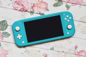 Switch lite on spring flower background photo