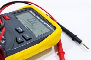 Digital multimeter on white background photo