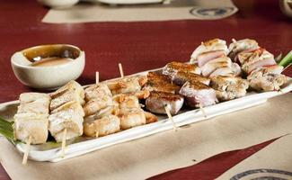 Mixed skewers chicken meat fish and cow photo