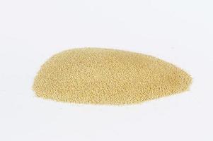 Heap of raw Quinoa seeds on white background photo