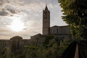 St. Chiara church in Assisi, Umbria, Italy at dusk with clouds