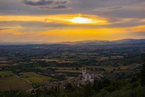Basilica of San Francesco in Assisi with a splendid sunset