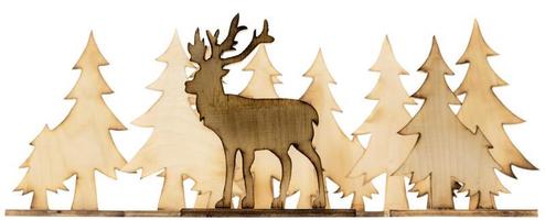 Cut out deer figure made of wood with dark edges and wooden fir trees photo