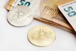 Bitcoin coins and Euro banknotes Cryptocurrency versus fiat money concept