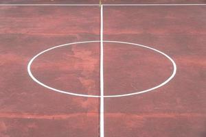 Multi sport game court with aged red floor photo