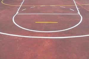 Multi sport game court with aged red floor photo