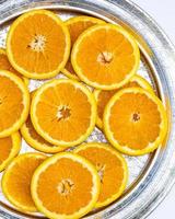 Overhead shot of Florida oranges cut on a silver tray photo