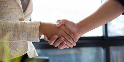 Close up of Business people shaking hands finishing up meeting business etiquette congratulation merger photo