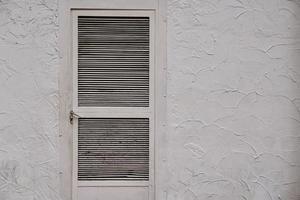 door on the white facade of the building photo