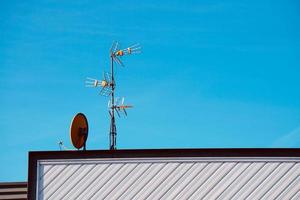 television antena on the rooftop of the house photo